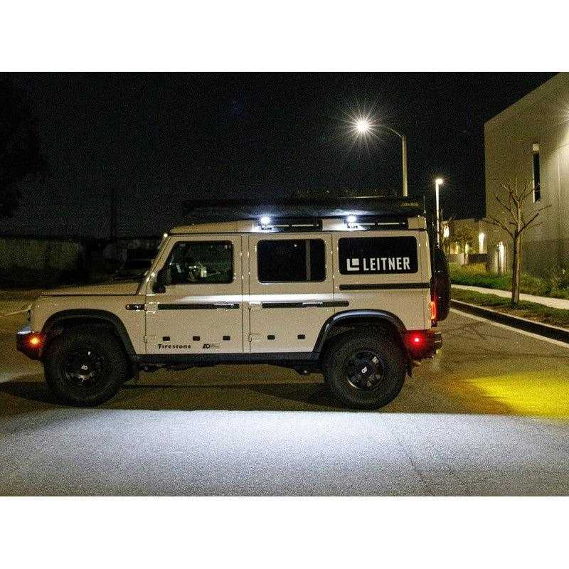 leitner-ineos-grenadier-chase-light-bracket-side-view-with-chase-lights-on-vehicle-beside-building