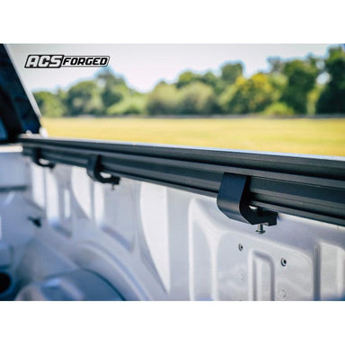 leitner-rail-clamp-acs-forged-rear-corner-view-on-truck-bed-in-nature