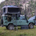 overland-vehicle-systems-bushveld-hard-shell-roof-top-tent-open-sideview-on-land-rover-defender-in-the-mountains