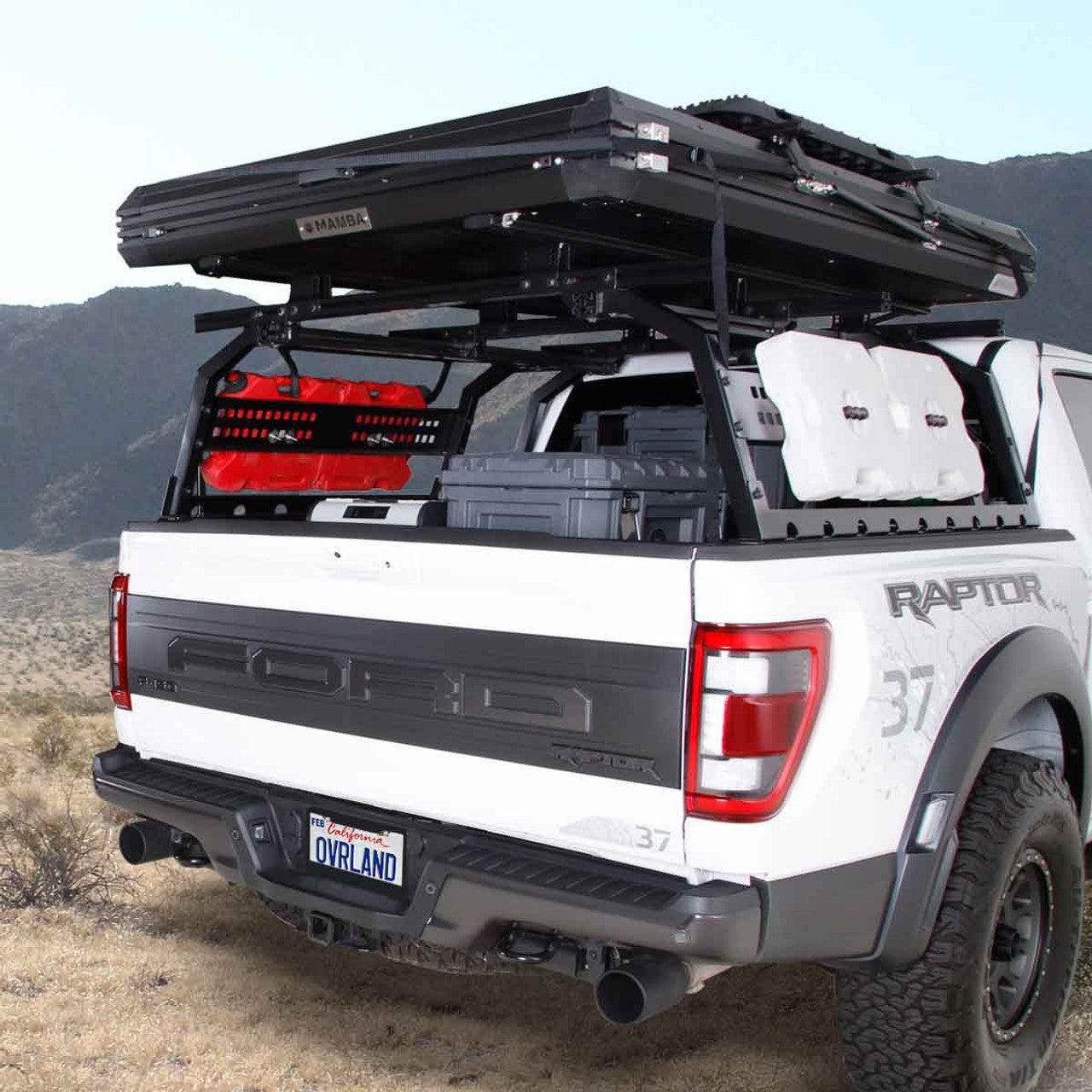 overland-vehicle-systems-discovery-rack-full-size-truck-short-bed-rear-view-on-ford-raptor-in-nature