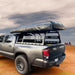 overland-vehicle-systems-discovery-rack-rear-corner-view-on-toyota-tacoma-with-roof-top-tent-and-awning-in-desert