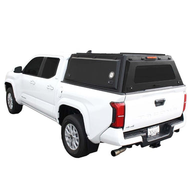 overland-vehicle-systems-expedition-truck-cap-black-for-2024_-toyota-tacoma-rear-corner-view-on-natural-backgound