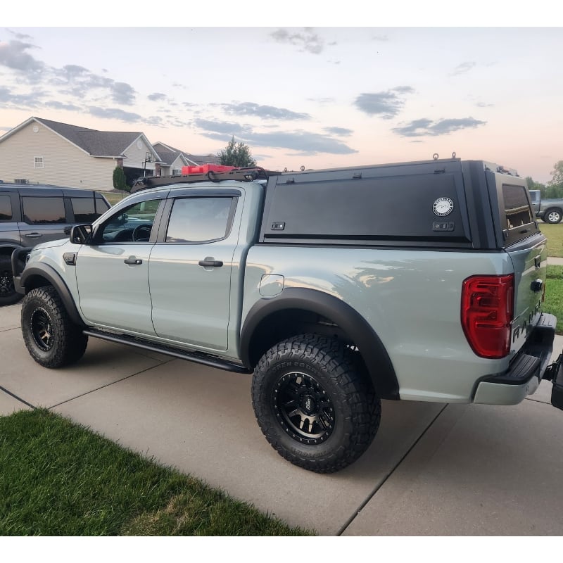 overland-vehicle-systems-expedition-truck-cap-for-ford-ranger-black-rear-corner-view-on-truck-in-driveway