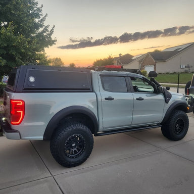 overland-vehicle-systems-expedition-truck-cap-for-ford-ranger-black-side-view-on-truck-in-driveway