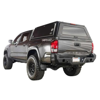 overland-vehicle-systems-expedition-truck-cap-for-toyota-tacoma-black-closed-gullwing-windows-rear-corner-view-on-toyota-tacoma-on-white-background