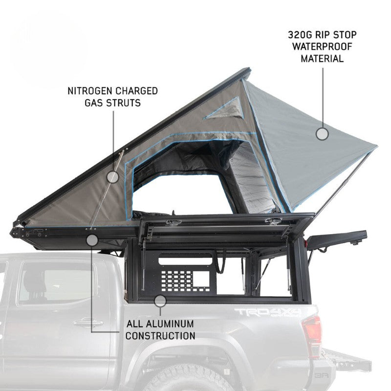 overland-vehicle-systems-magpak-camper-shell-roof-top-tent-for-jeep-gladiator-open-side-view-on-vehicle-gas-struts-on-white-background