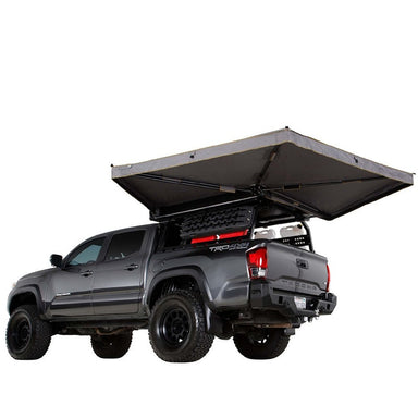 overland-vehicle-systems-nomadic-270lte-awning-driver-side-toyota-tacoma-corner-view-and-rear-view