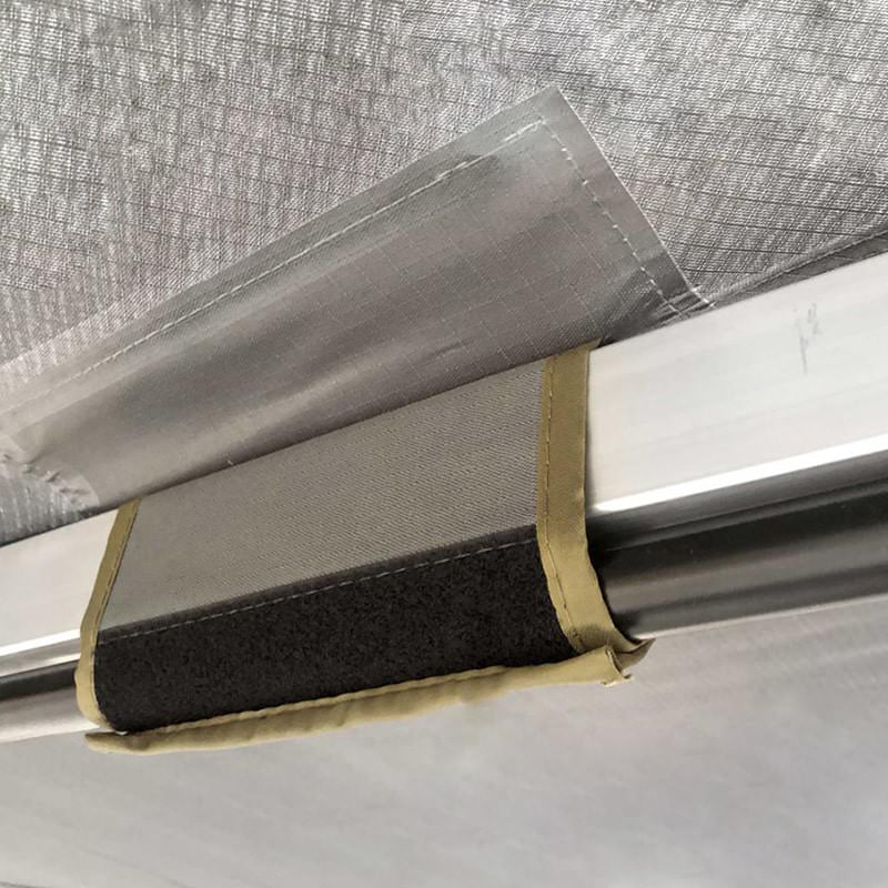 overland-vehicle-systems-nomadic-awning-180-dark-gray-open-close-up-view-of-support-pole-velcro-fitting
