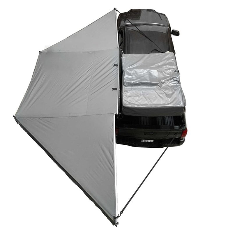 overland-vehicle-systems-nomadic-awning-180-driver-side-dark-gray-open-drone-view-toyota-tacoma-on-white-background