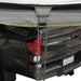 overland-vehicle-systems-nomadic-awning-180-for-mid-high-roofline-vans-open-close-up-view-of-tie-down-cords-on-toyota-tacoma