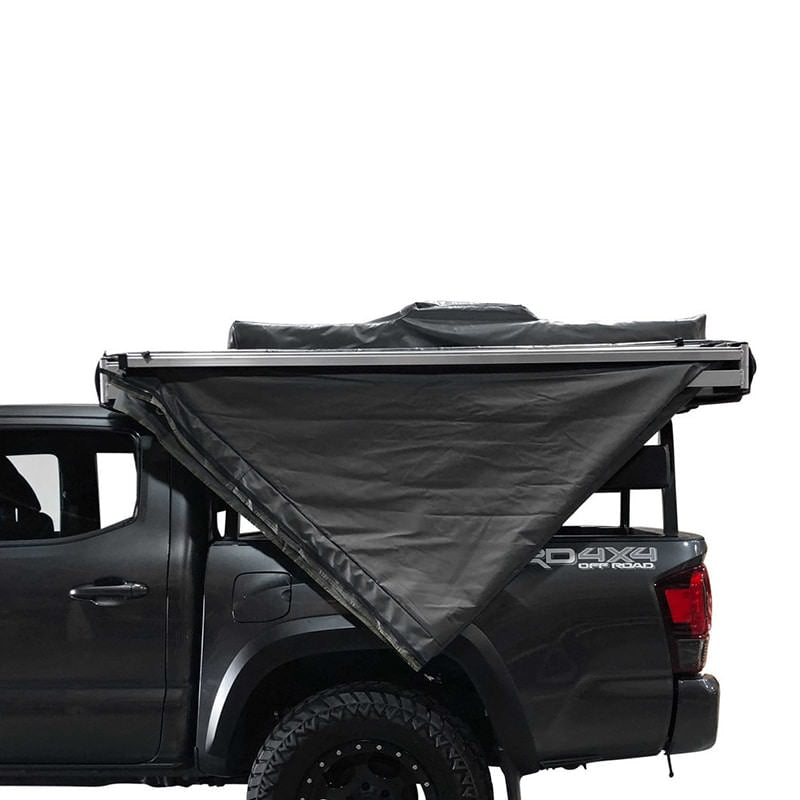 overland-vehicle-systems-nomadic-awning-180-for-mid-high-roofline-vans-side-view-unzipped-travel-bag-on-toyota-tacoma
