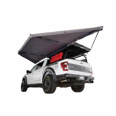 overland-vehicle-systems-nomadic-awning-180-lte-gray-open-rear-corner-view-on-ford-raptor-on-white-background