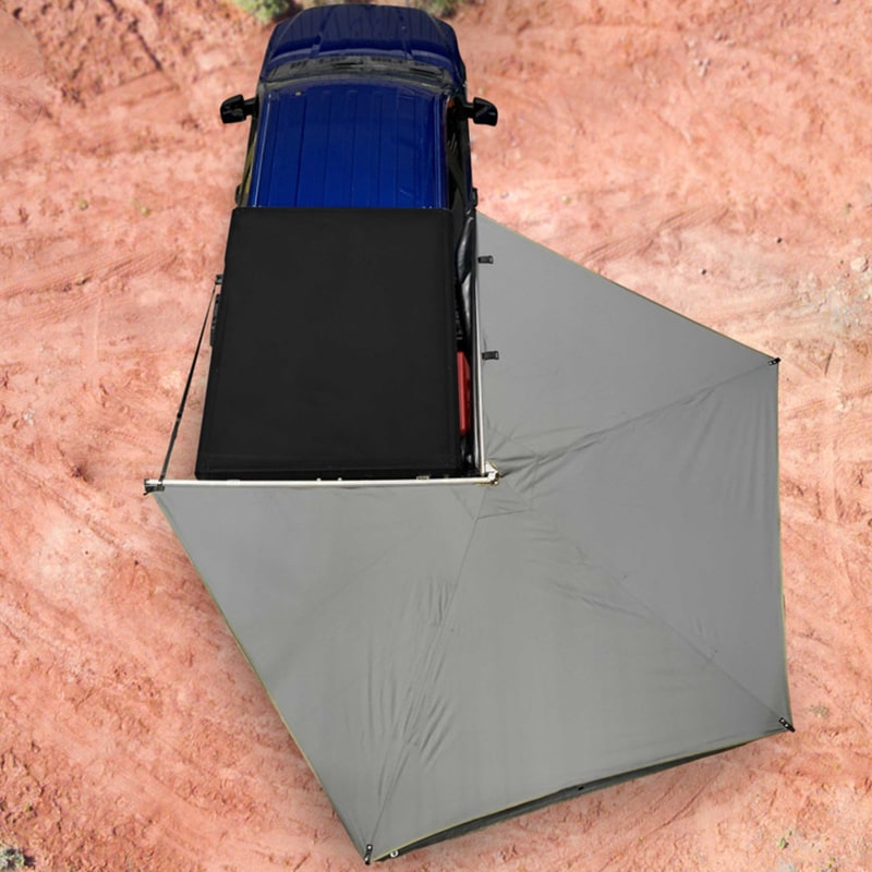 overland-vehicle-systems-nomadic-awning-270-lt-passager-side-dark-gray-open-drone-view-on-ford-ranger-in-desert