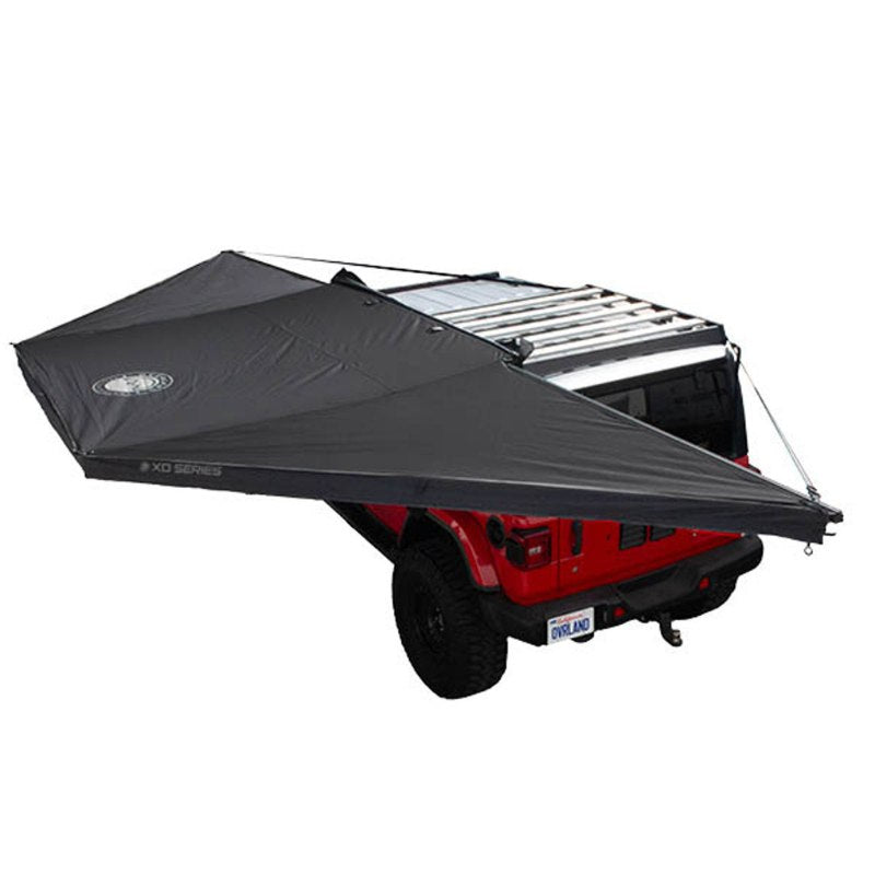 overland-vehicle-systems-xd-nomadic-180-awning-with-lights-and-black-out-open-rear-corner-view-on-vehicle-on-white-background