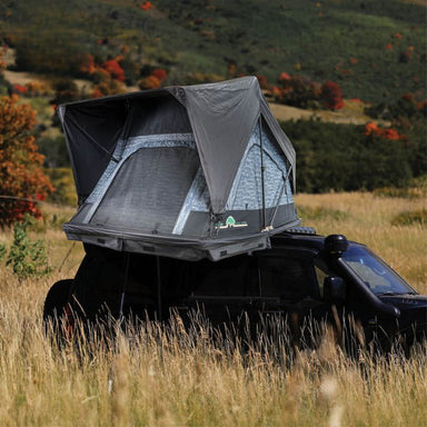 overland-vehicle-systems-xd-sherpa-soft-shell-rooftop-tent-gray-body-black-rainfly-open-front-corner-view-on-land-cruiser-in-field