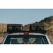 roam-83l-rugged-case-black-side-view-on-vehicle-in-nature