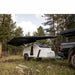 roam-arc-180-awning-front-corner-view-on-trailer-in-nature