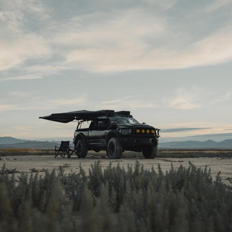 roam-arc-180-awning-open-front-corner-view-on-vehicle-in-nature