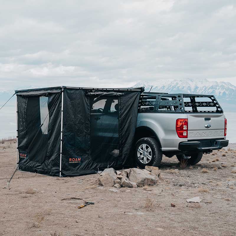 roam-standard-awning-room-black-front-corner-view-on-vehicle-in-nature