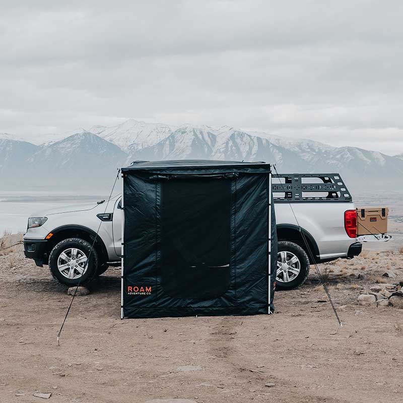 roam-standard-awning-room-black-front-view-on-vehicle-in-nature