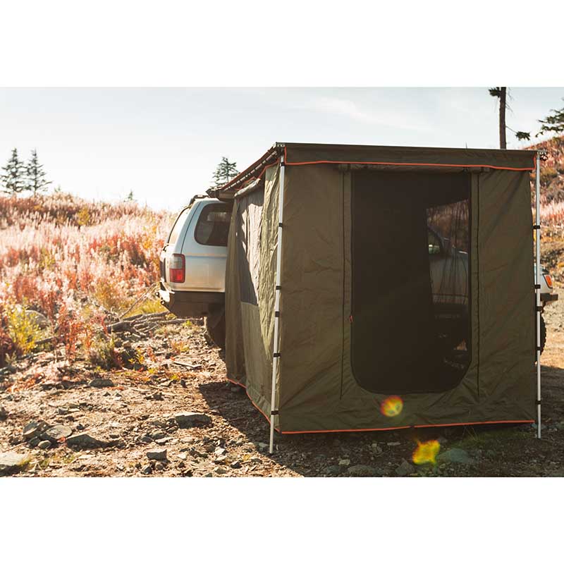 roam-standard-awning-room-forest-green-hyper-orange-front-view-on-vehicle-in-nature