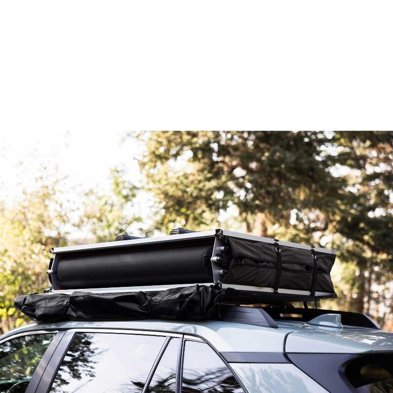 roam-vagabond-lite-rooftop-tent-black-closed-front-view-on-car-in-forest