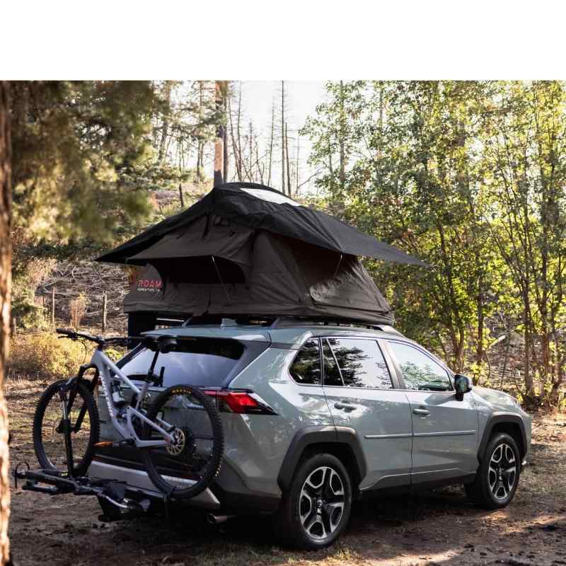 roam-vagabond-lite-rooftop-tent-black-open-side-view-on-toyota-rav4-with-bike-in-nature