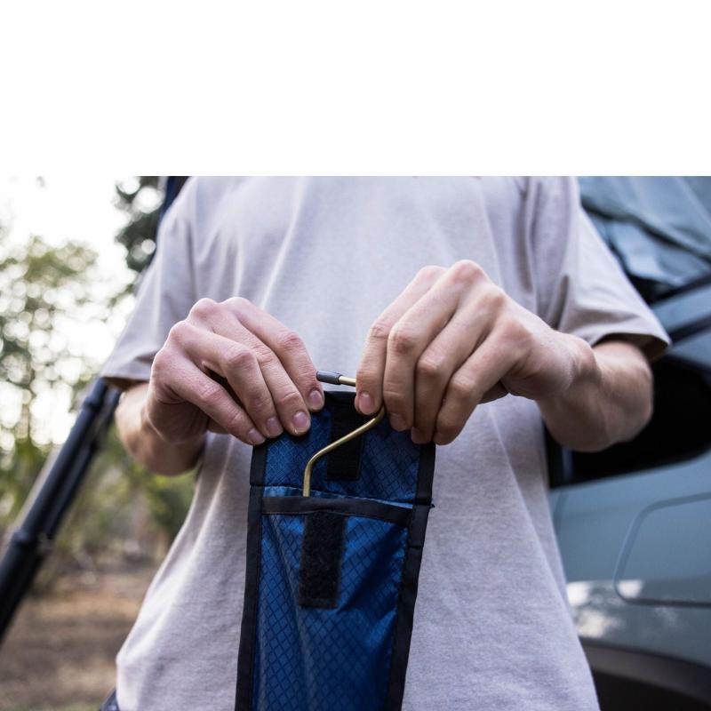 roam-vagabond-lite-rooftop-tent-close-up-view-with-person-holding-rainfly-rods