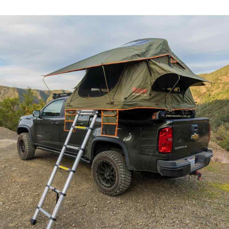 roam-vagabond-lite-rooftop-tent-forest-green-hyper-orange-open-front-corner-view-on-chevrolet-colrado-in-nature