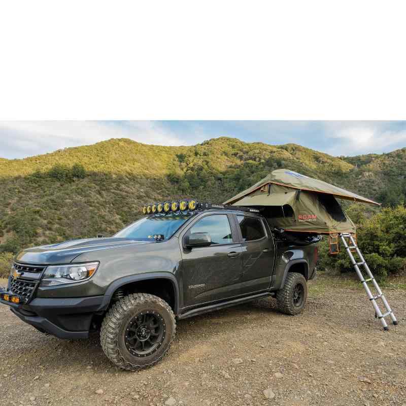 roam-vagabond-lite-rooftop-tent-forest-green-hyper-orange-open-side-view-on-chevrolet-colrado-with-ladder-in-nature