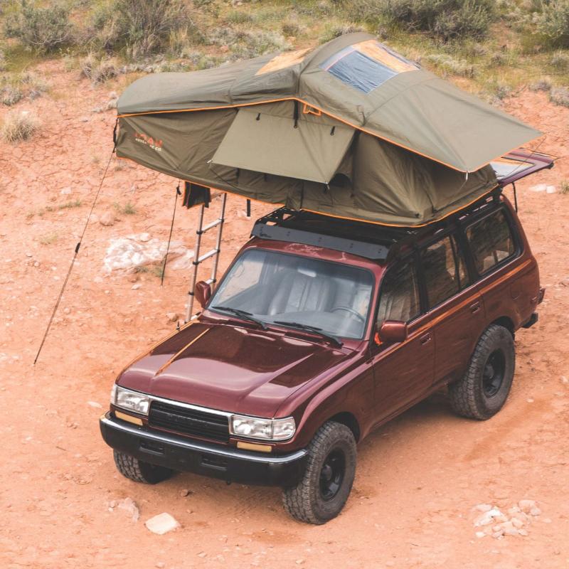 roam-vagabond-rooftop-tent-forest-green-hyper-orange-open-drone-view-on-toyota-land-cruiser-in-nature