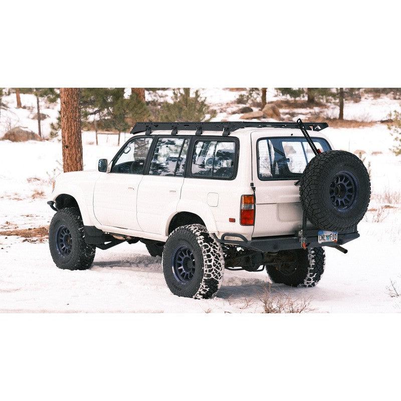 sherpa-la-sal-roof-rack-for-1990-1997-land-cruiser-80-series-rear-corner-view-with-spare-tire-in-nature