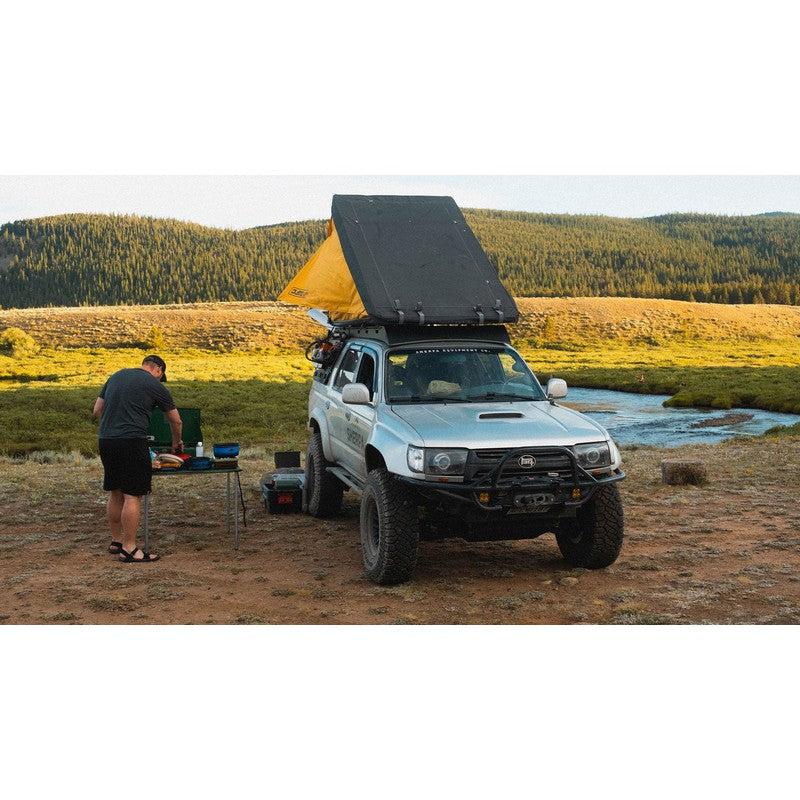 sherpa-matterhorn-roof-rack-for-1996-2002-4runner-front-view-with-person-and-rooftop-tent-in-nature