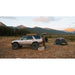 sherpa-matterhorn-sport-roof-rack-for-1996-2002-4runner-side-view-with-person-and-tent-in-nature