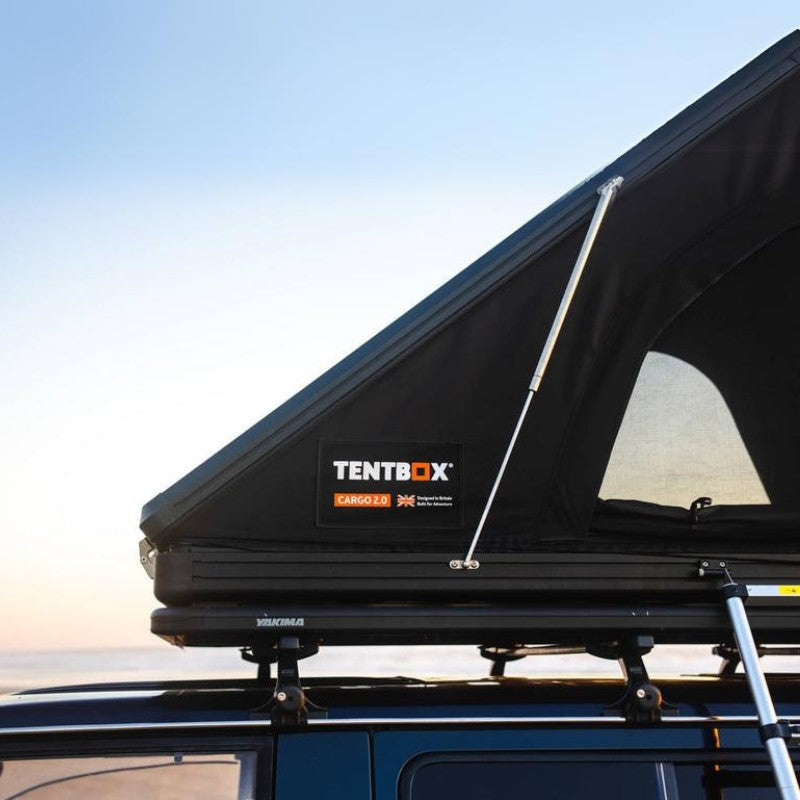 tentbox-cargo-2-hard-shell-roof-top-tent-midnight-gray-open-close-up-view-on-vehicle-with-struts-and-logo-in-nature