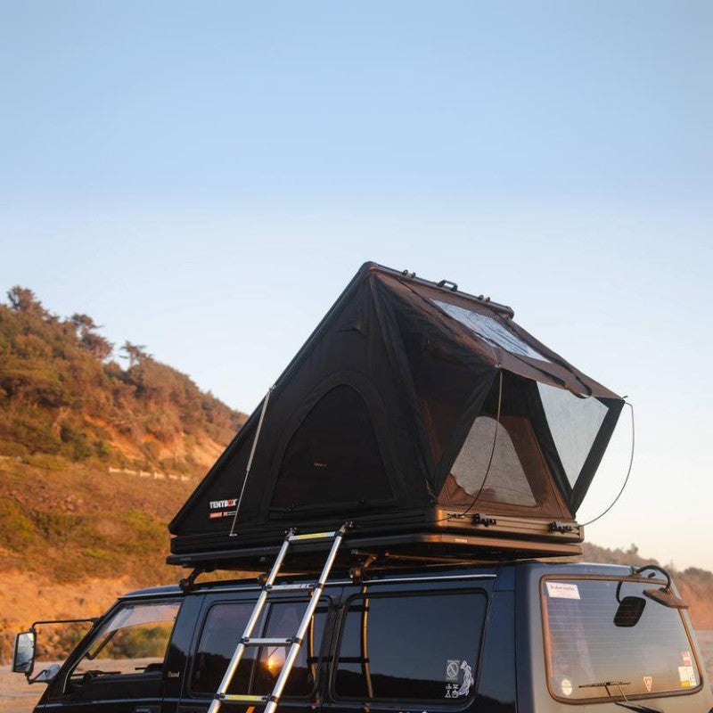 tentbox-cargo-2-hard-shell-roof-top-tent-midnight-gray-open-front-corner-view-on-mitsubishi-delica-with-ladder-in-nature