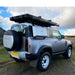 tentbox-cargo-hard-shell-roof-top-tent-closed-rear-corner-view-on-land-rover-new-defender-in-nature