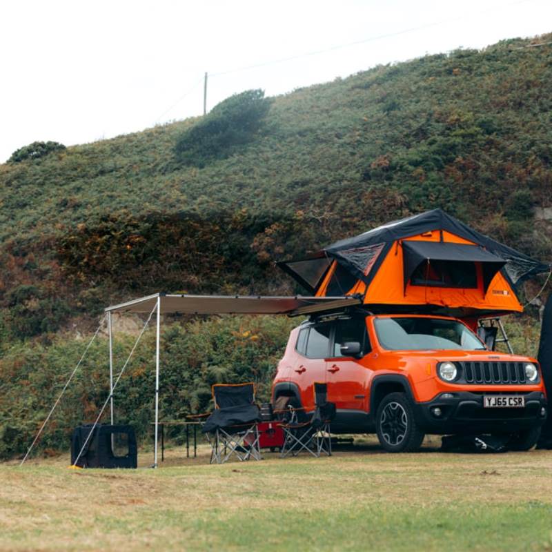 tentbox-lite-1-0-soft-shell-roof-top-tent-orange-open-front-view-on-jeep-on-campsite