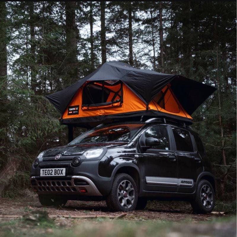 tentbox-lite-2-0-soft-shell-roof-top-tent-sunset-orange-open-front-corner-view-on-fiat-panda-cross-in-forest