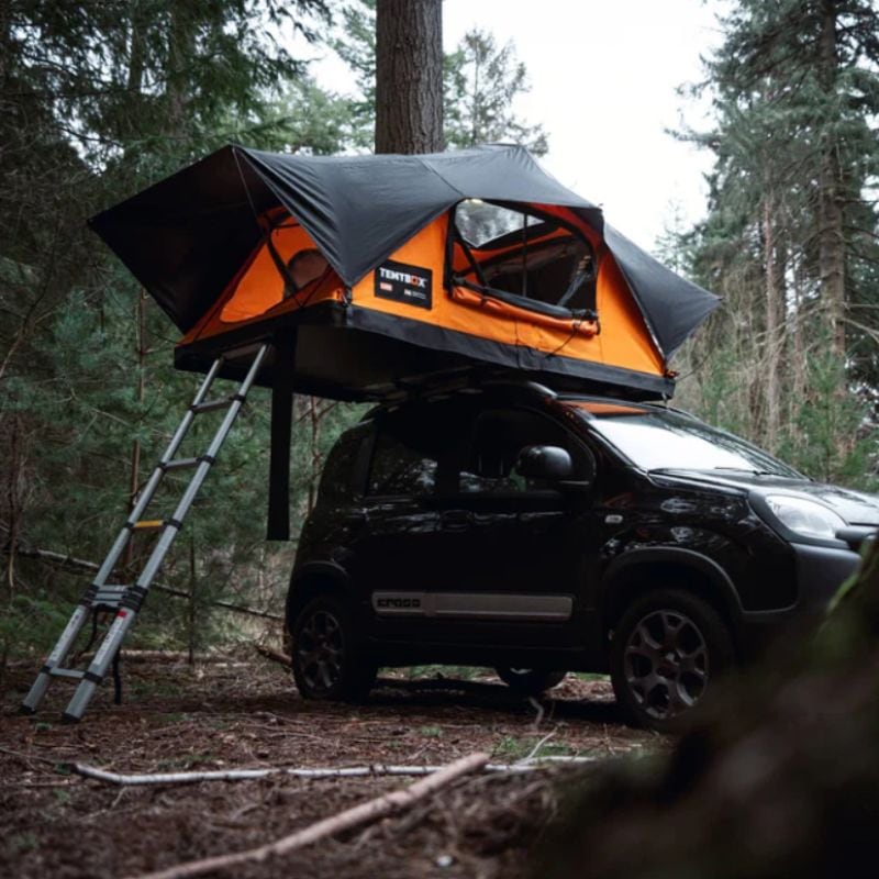 tentbox-lite-2-0-soft-shell-roof-top-tent-sunset-orange-open-with-ladder-front-corner-view-on-fiat-panda-cross-in-forest