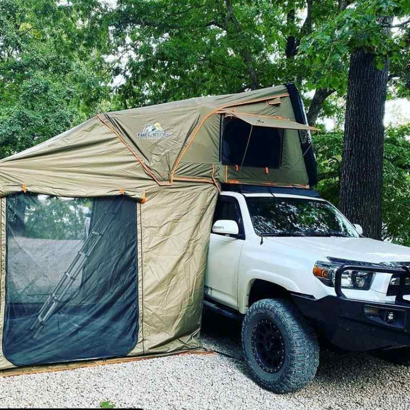 tuff-stuff-alpha-hard-shell-roof-top-tent-2-3-person-with-annex-black-open-on-toyota-in-nature