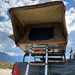 tuff-stuff-alpha-hard-shell-roof-top-tent-2-person-black-open-with-ladder-on-bed-rack-in-nature