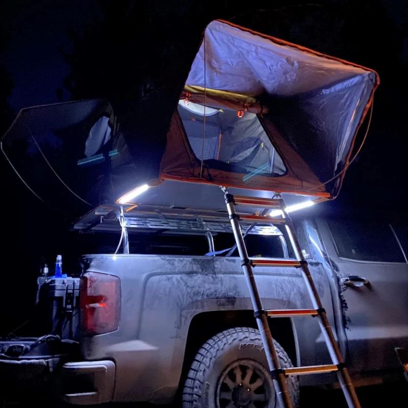 tuff-stuff-alpha-hard-shell-roof-top-tent-2-person-open-on-bed-rack-led-lights-in-nature