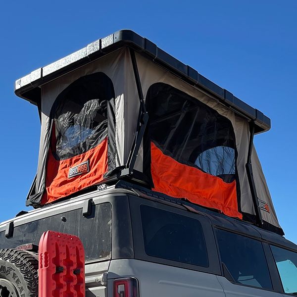badass-tents-recon-pop-up-roof-top-tent-open-rear-side-view-with-insect-mesh-closed-on-ford-bronco