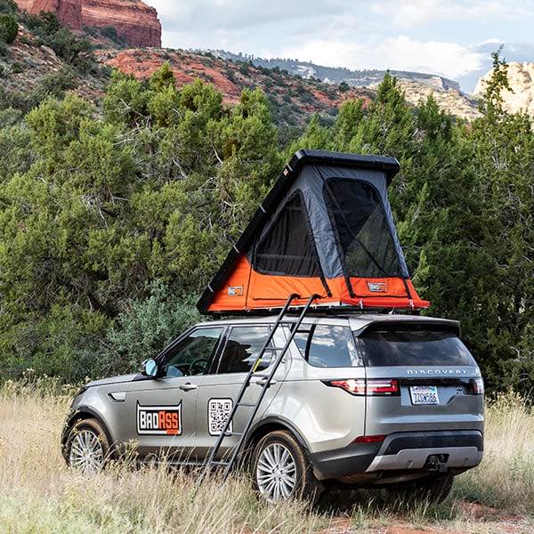 badass-tents-rugged-clamshell-roof-top-tent-open-rear-corner-view-on-land-rover-discovery-5